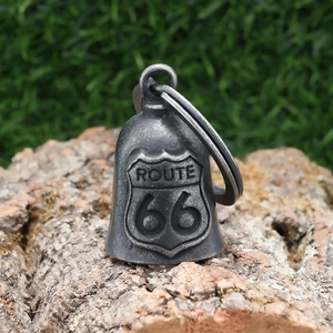 Detailed macro shot of vintage Route 66 stainless steel biker bell on natural bark base