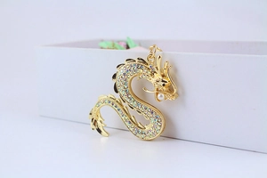 Détail d'un porte-clés dragon doré orné de strass colorés et d'une perle élégante