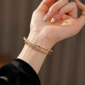 Detail of gold double-layered bracelet with colorful cubic zirconia on woman wrist