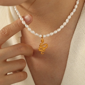 Retro titanium steel necklace with gold snake pendant and natural freshwater pearls on model