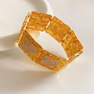Vintage gold square link bracelet with baroque spiral pattern in 45-degree angle view