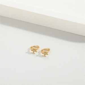 Exquisite gold floral stud earrings with centered white zircon on a white background