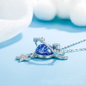 Cosmos planet necklace with blue stone and cubic zirconia star on a silver chain