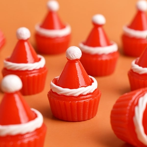 Macro shot of miniature red Christmas hat resin figurines for holiday DIY decor