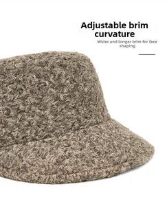 Detail of warm brown lamb wool fabric with foldable wide brim for face-framing style