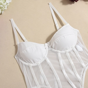 Detail of white mesh lace corset top featuring satin boning and delicate bow center