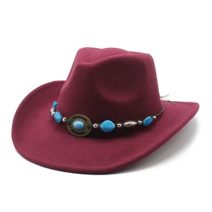 Detail of burgundy wool felt cowboy hat featuring turquoise beads and ethnic metal buckle