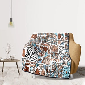Artistic graffiti flannel blanket with SUN SHINE print draped on a yellow chair