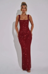 Macro shot of dark red sequins on a formal sleeveless evening gown showing texture