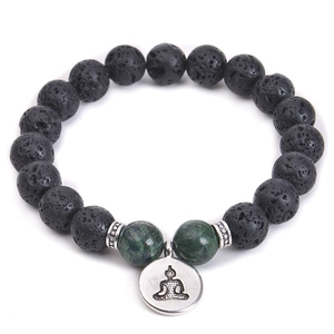 Detailed shot of black lava stone bracelet with green beads and silver Buddha pendant