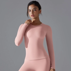 Detail view of pink long sleeve yoga top and high waist leggings with elastic texture