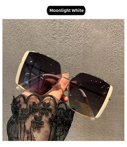Detail of oversized moonlight white square sunglasses with elegant gradient lenses