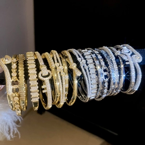 Detailed view of 18k gold plated bracelets set with sparkling zircon in various designs