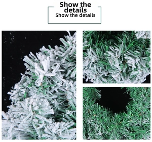 Close-up of artificial PVC Christmas wreath showing realistic snow flocking on green pine needles