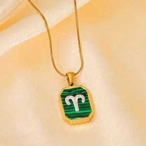 Gold Aries necklace featuring green malachite pendant with sparkling crystal inlay
