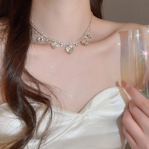 Close-up of heart-shaped zircon fringe necklace with elegant sparkling crystal pendants