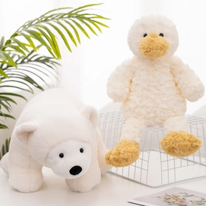 Soft plush polar bear and duckling stuffed animals on a minimalist white shelf