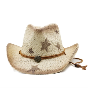 Straw cowboy hat with brown star prints and vintage metallic buckle detail on white backdrop