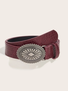 Detail of dark burgundy faux crocodile leather belt with vintage oval silver buckle