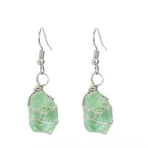 Detailed wire-wrapped silver earrings featuring raw light green natural crystal stones