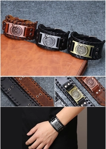 Detail of Viking style wide leather bracelets with compass alloy charm and metal rivets