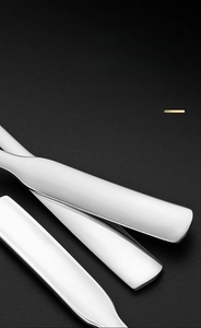 Close-up of thickened square handle on polished 304 stainless steel spoon with rounded edges