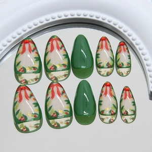 Christmas almond nails with red bow, holly leaves, gold foil and glitter finish