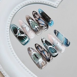 Cat eye irregular long press-on nails with silver glitter, butterfly design and 3D gems