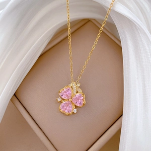 Macro shot of titanium steel necklace with pink heart-shaped zircon flower pendant
