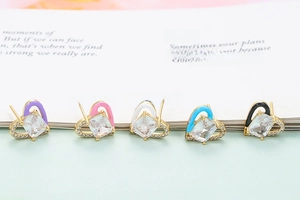 Detailed view of five colorful heart-shaped stud earrings with micro-set zircons