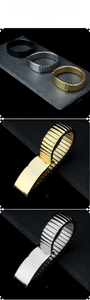 Detailed close-up of elastic stainless steel link bracelet in gold, silver, and black