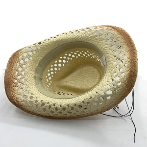 Detail of hollow woven straw cowboy hat with interior sweatband and material label