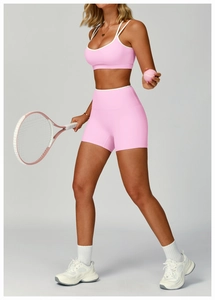 Pink sports bra and high-waist shorts set with white trim and tennis racket