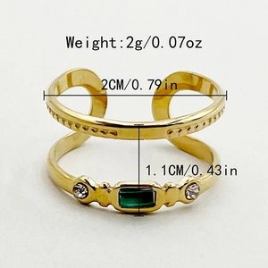Detail shot of golden open ring with green gemstone showing dimensions and 2g weight