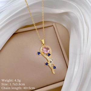 Detail of snake necklace with pink and blue stones in jewelry box and dimensions text