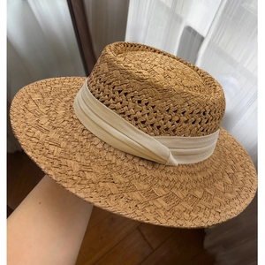 Handmade woven flat top straw boater hat with cream ribbon for summer beach vacation