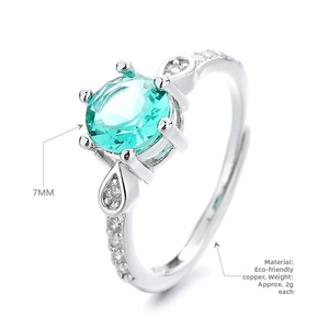 Macro detail of 7mm round green stone ring with six-prong setting and silver plated band