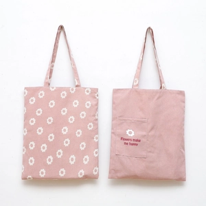 Detail showing pink canvas tote bags with daisy prints and flower pocket design