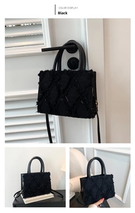 Detail of black quilted denim handbag showing textures and handle on a door