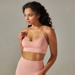 Detail of light pink seamless knit yoga bra with V-neck and thin adjustable shoulder straps