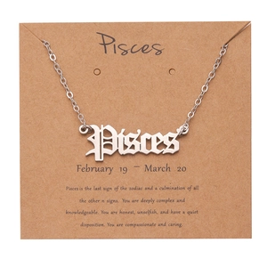 Silver Pisces zodiac pendant necklace on informative paper card with personality traits