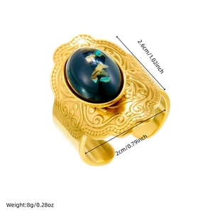Vintage gold-plated stainless steel ring with oval black stone and intricate carving