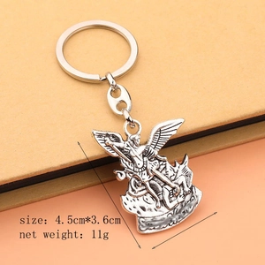 Silver Archangel Saint Michael metal keychain pendant on minimalist background