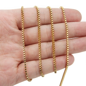 Detail shot of 18k gold plated stainless steel box chain held for size reference