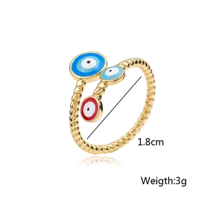 Detailed view of gold evil eye open ring with colorful enamel inlay and twisted rope band