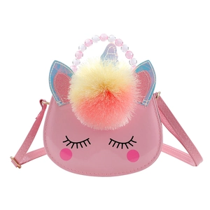 Detail of pink unicorn kids crossbody bag with beaded handle and colorful pompom