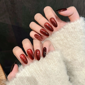 Cat eye deep red almond press-on nails with magnetic shimmer and long oval shape