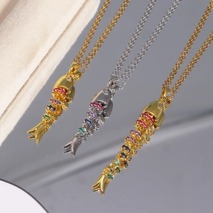 Detailed close-up of flexible articulated fish pendants with colorful zircon crystals