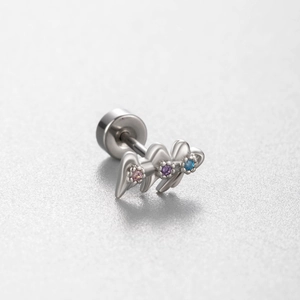 Silver steel wing cartilage stud with pink, purple and blue gemstones on a gray surface