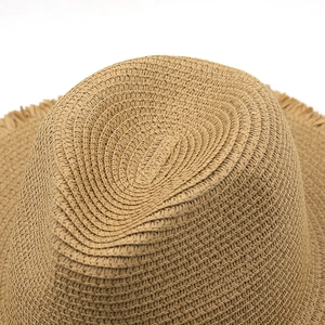 Detail of khaki raffia straw fedora showing spiral weave texture and frayed edge brim